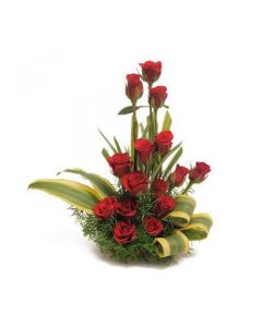 Beautiful Basket arrangement of 18 red roses with draceane leaves and lots of fillers